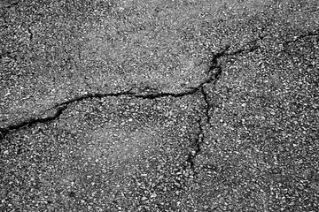 Obraz premium crack and texture of asphalt road - top view background.