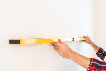 cropped view of man measuring wall at home