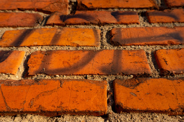 Old brick wall with graffiti fragments