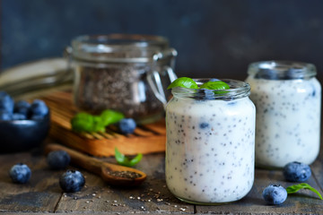 Homemade yogurt with sesena chia and blueberries that have a dark background. Proper nutrition.