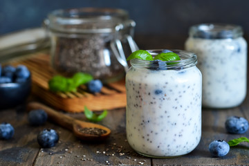 Homemade yogurt with sesena chia and blueberries that have a dark background. Proper nutrition.