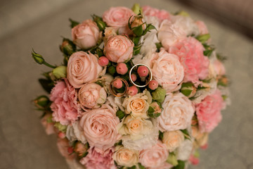 wedding engagement rings are on the wedding bouquet