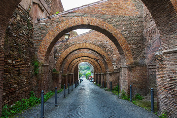 Ancient street with arches in the center of Rome