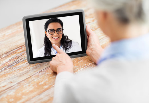 Medicine, Technology And Healthcare Concept - Senior Woman Patient Having Video Call With Doctor On Tablet Pc Computer At Home