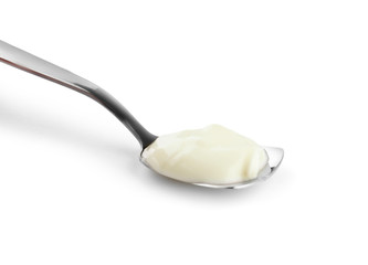 Spoon with tasty yogurt on white background