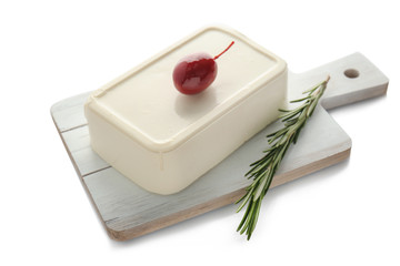 Board with tasty feta cheese on white background