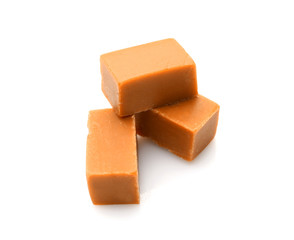 Tasty sweet caramel on white background