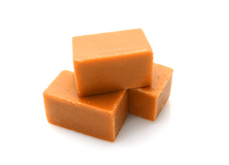 Tasty sweet caramel on white background
