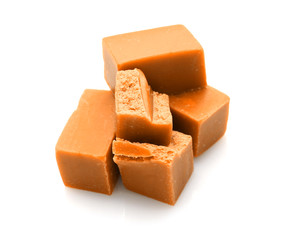 Tasty sweet caramel on white background