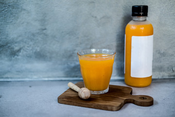 Orange juice in a glass and a bottle