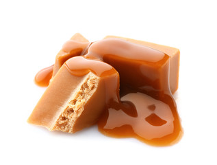 Tasty caramel candies on white background