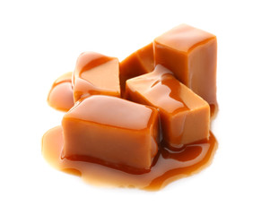 Tasty caramel candies on white background