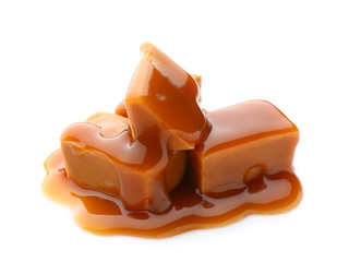 Tasty caramel candies on white background