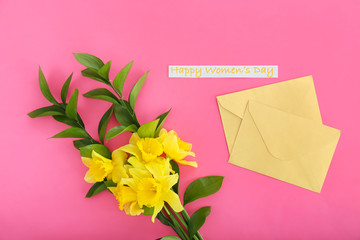 Envelopes with beautiful flowers for International Women's Day on color background