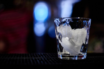 glass of water with ice on black background