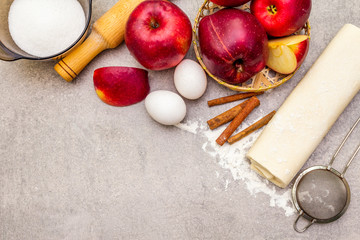 Apple pie ingredients baking concept. Fresh apples with cinnamon, flour, sugar, eggs. Cooking...
