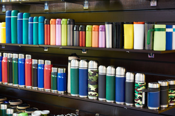 Colored vacuum flasks in shop