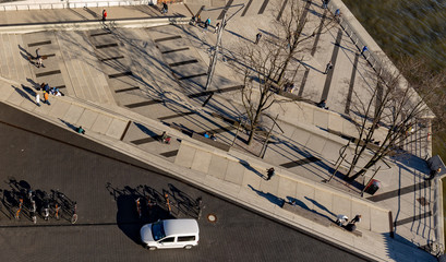 People look small from above despite long shadows
