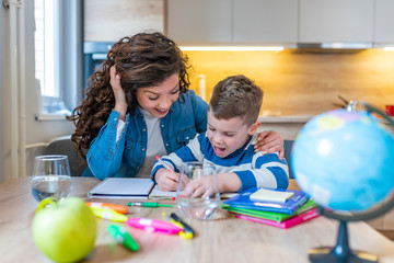 Mom helping her son do his homework.