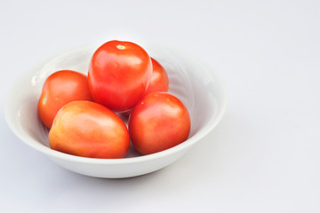 Fresh tomatoes in a bowl isolated background space for text