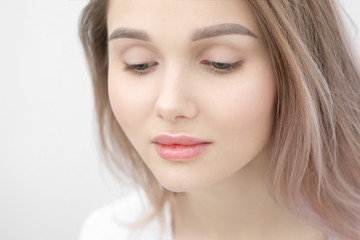 Obraz premium Close-up of the face of a beautiful young blonde girl with smooth skin.