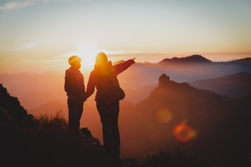 mother and son travel in mountains at sunset, family hiking in nature
