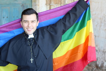 Liberal priest holding the rainbow flag
