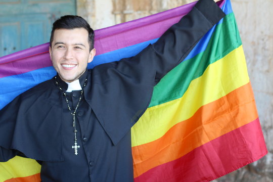 Liberal Priest Holding The Rainbow Flag