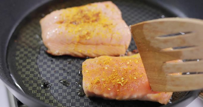 Salmon fry in the pan. Cooking fish steak.