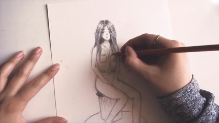 Woman drawing a picture of a girl. Sketching a character. Art and design.