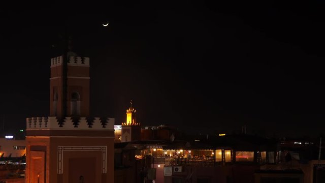 Mosque and restaurant at night. Marrakech, Morocco.