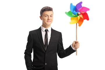 Young guy in a suit with a colorful pinwheel