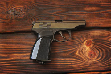Gun on the wooden background