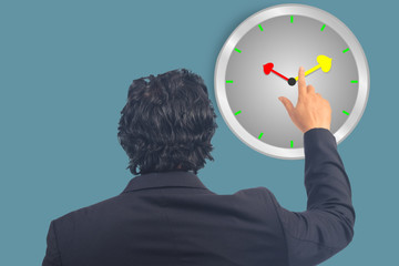 Business man point to clock on background.