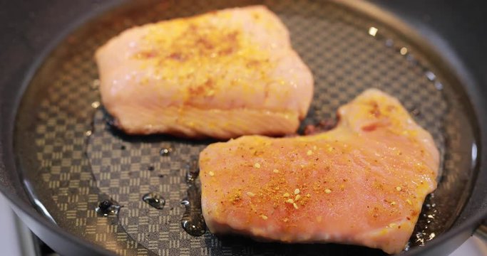 Salmon fry in a pan. Cooking fish steak.