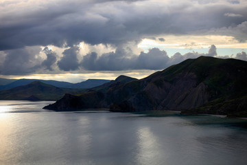 Beautiful natural landscape on the coast of Crimea. Storm clouds, mountains and sea