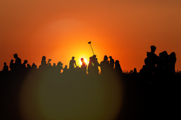 silhouettes of people taking pictures with smartphone