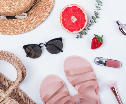 Feminine items like straw hat, sunglasses, sandals and other summer accessories