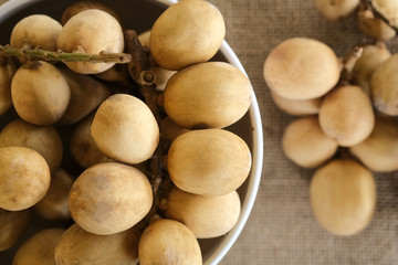 Malaysia's local fruit, langsat or Lansium parasiticum shot on isolated background. © Rafael