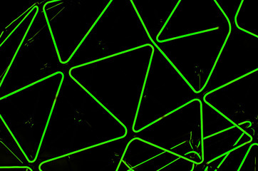 Rhythmic neon lines on a black background. Abstract picture.