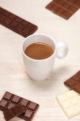 A lot of variety chocolates bar in box on white wooden background