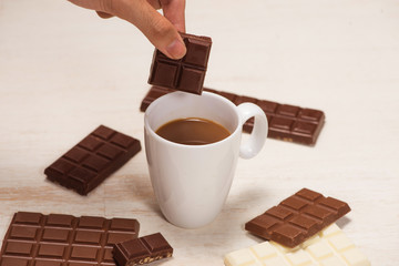 A lot of variety chocolates bar in box on white wooden background