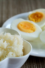 Sticky rice or glutinous rice and boiled eggs served in restaurant, high vitamin, mineral such as selenium, copper and phosphorous food useful for human growth, tradition Thai food and export product