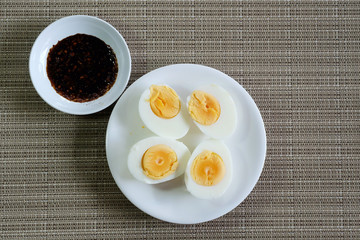 Hard boiled eggs in white dish served in restaurant with space for write wording, delicious high nutrition food that good for muscle, eye, bone and healthy growth for kids, patients and everyone