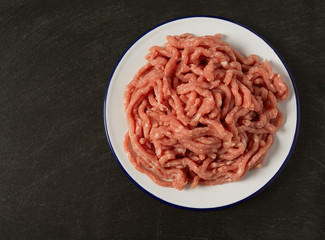 minced meat on black stone surface