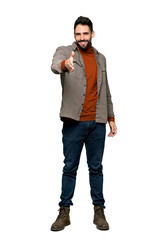 Fototapeta premium Full-length shot of Handsome man with beard shaking hands for closing a good deal on isolated white background