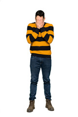 Naklejka premium Full-length shot of Handsome man with striped sweater with tired and sick expression on isolated white background