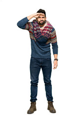 Fototapeta premium Full-length shot of Hippie man looking far away with hand to look something on isolated white background