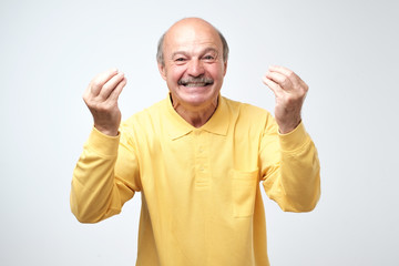 Attractive guy laughing, showing italian gesture, proving his point of view