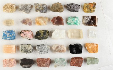 Set of minerals, a collection of rocks, minerals in the box on white cement background.